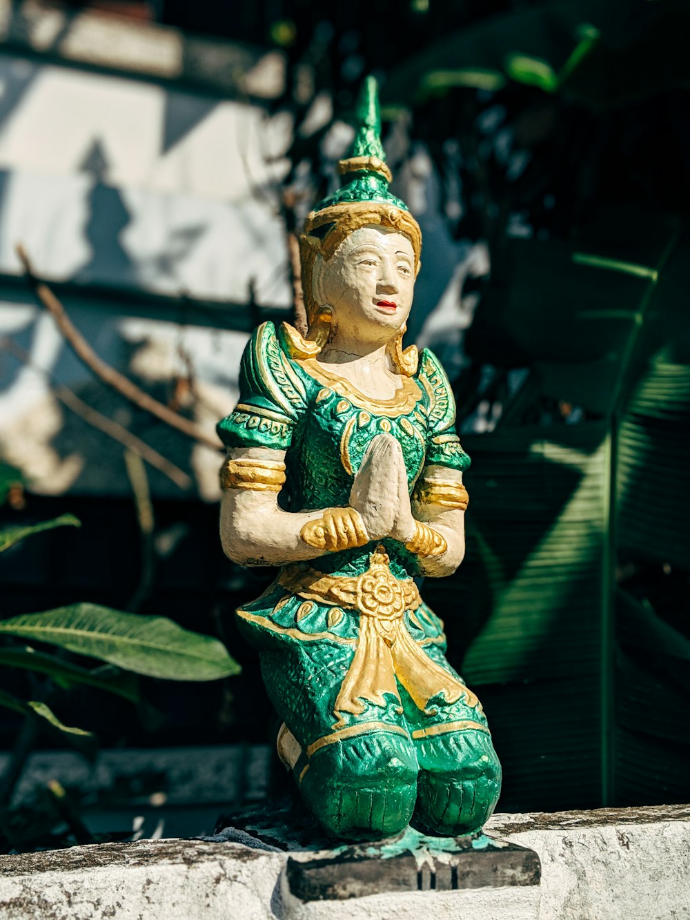 green and brown buddha figurine