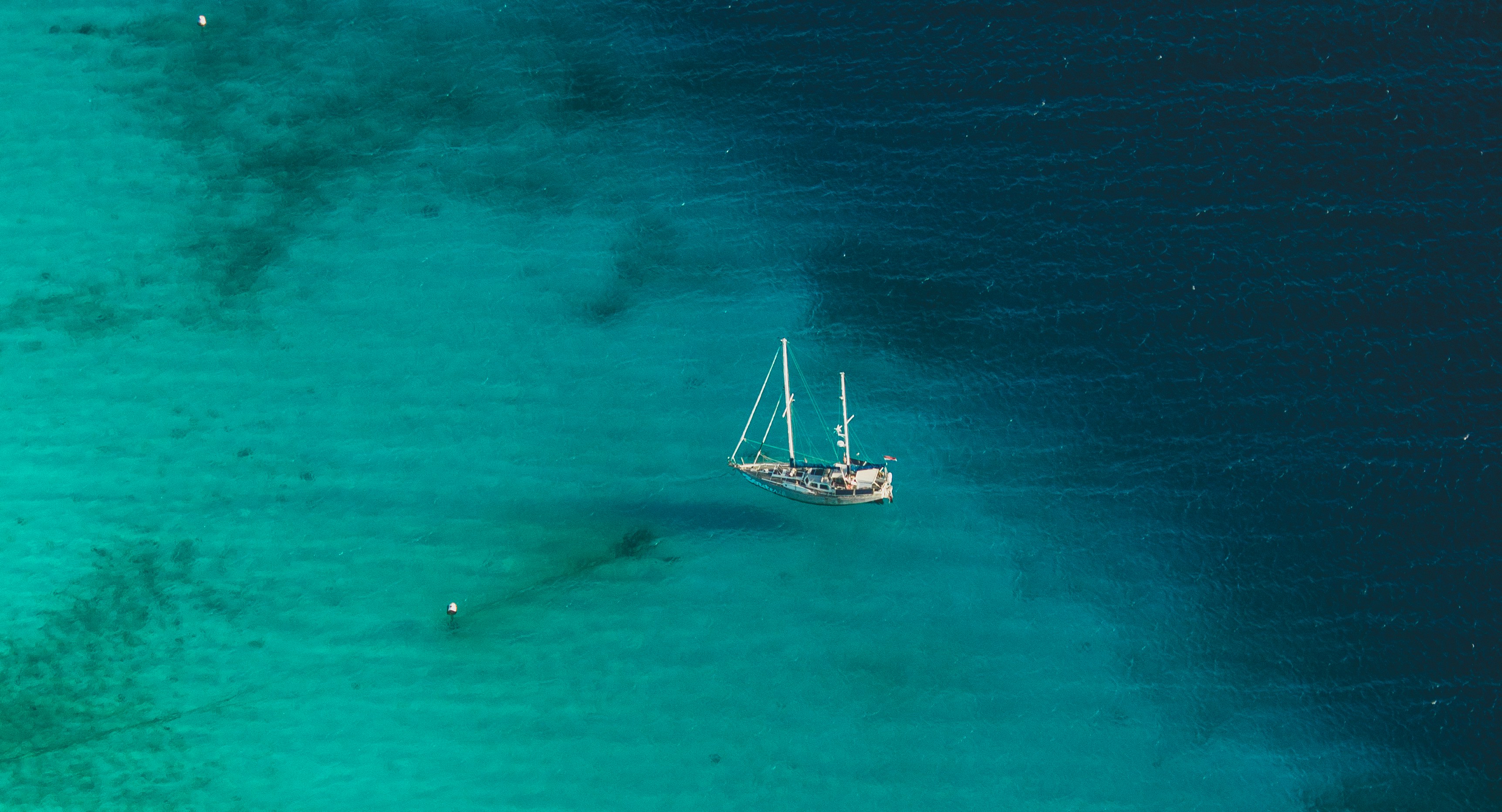 white sailboat on blue sea during daytime