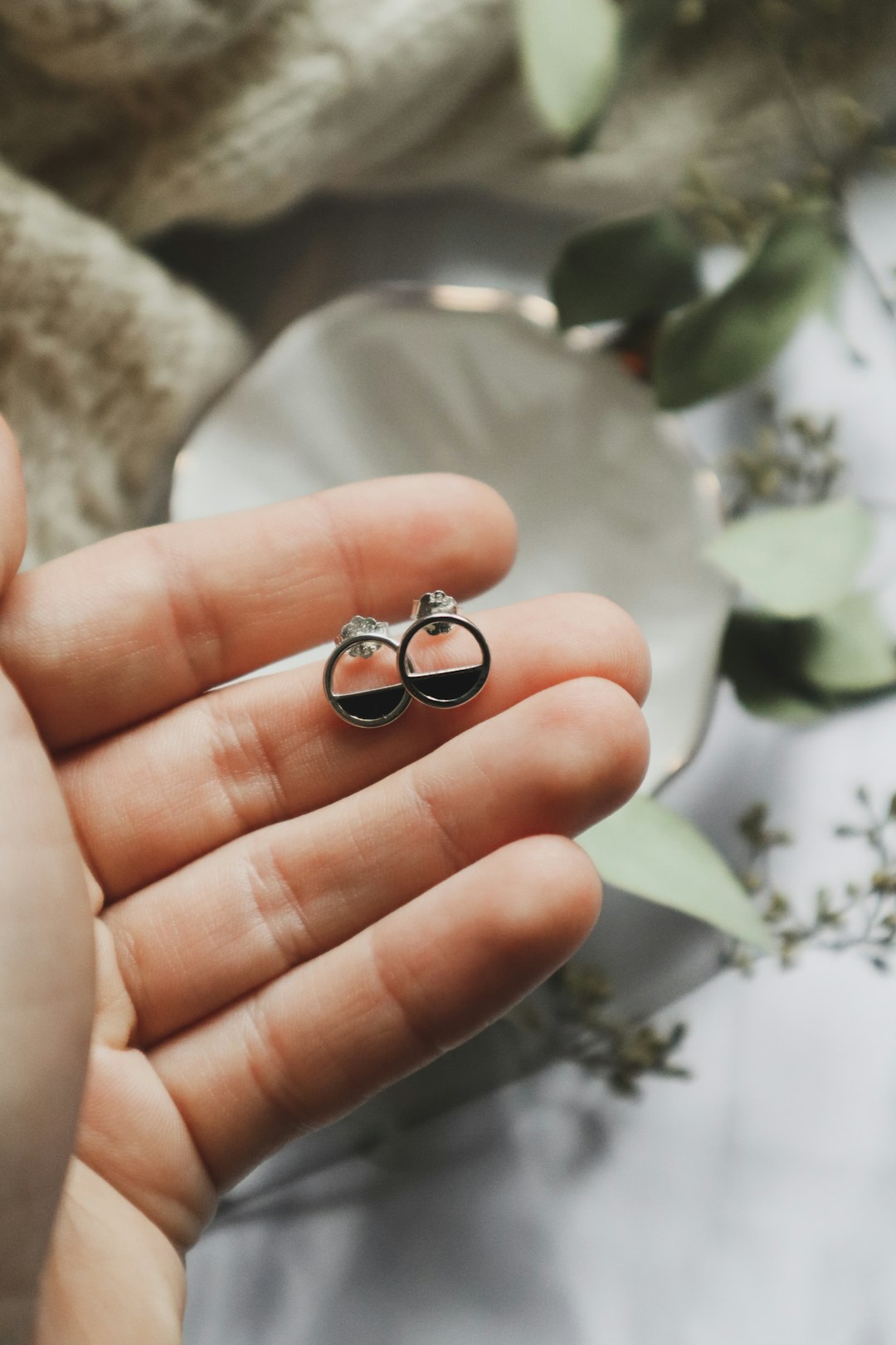 silver and black ring on persons hand