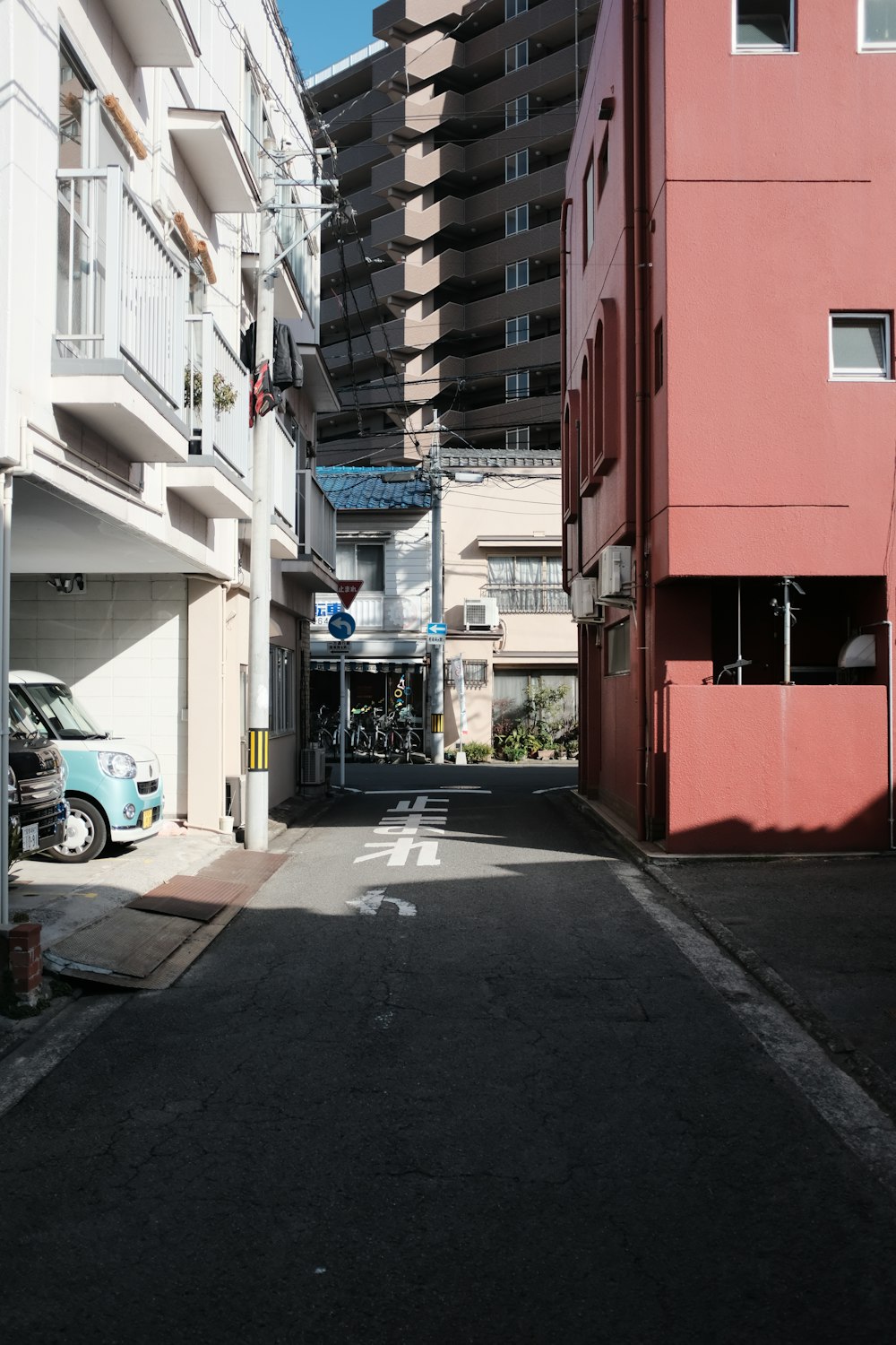 cars parked beside red building during daytime