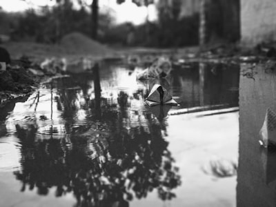 A sophisticated, minimalist scene of children playing with paper boats, captured in soft editorial style.
