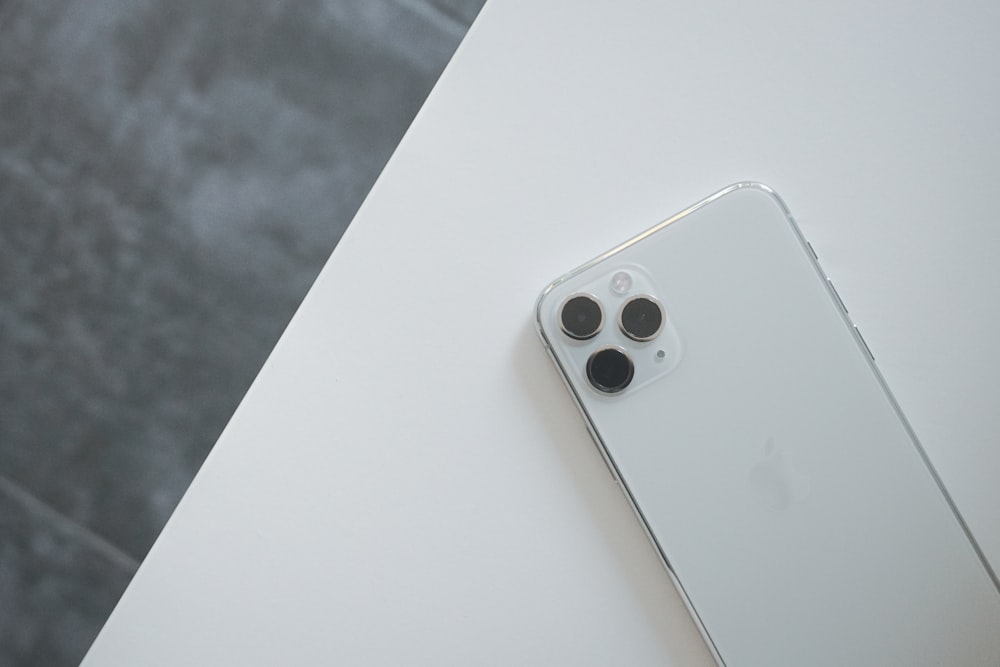 White refurbished iPhone on a white desk