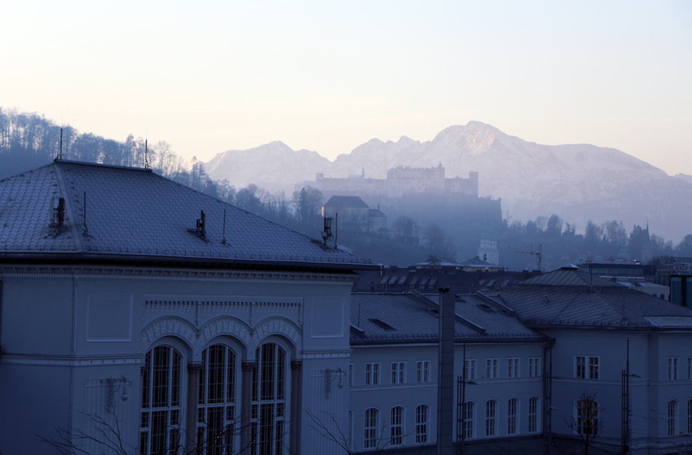 white concrete building near mountain during daytime