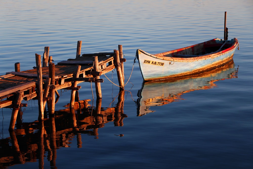 white and red boat on body of water during daytime