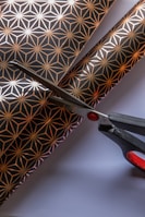 Artisan cutting delicate paper shapes with precision and care.