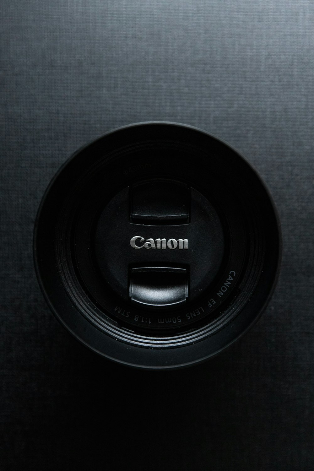black canon camera lens cover