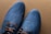 A stylish pair of shoes displayed on a wooden surface.