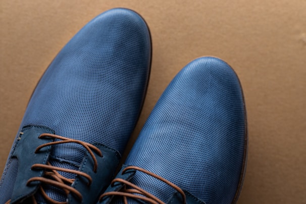 A stylish pair of shoes displayed on a wooden surface.