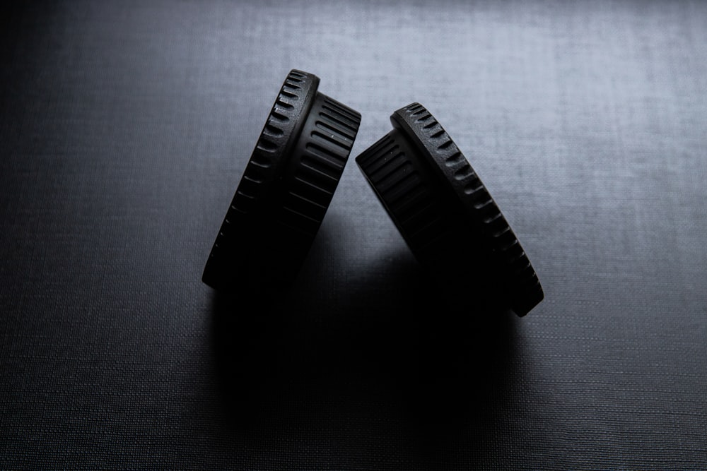 black plastic hair comb on gray textile