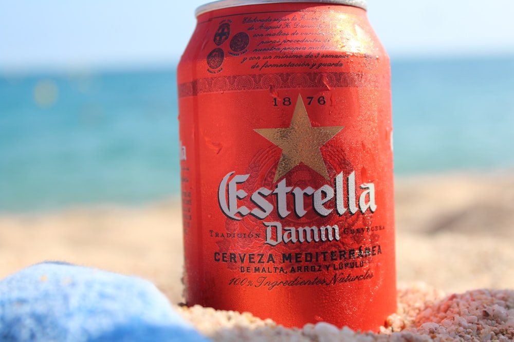 red and white can on white sand