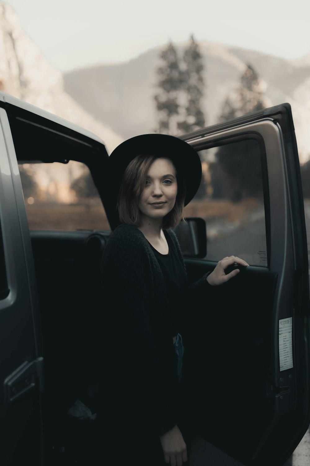 woman in black long sleeve shirt sitting on car seat