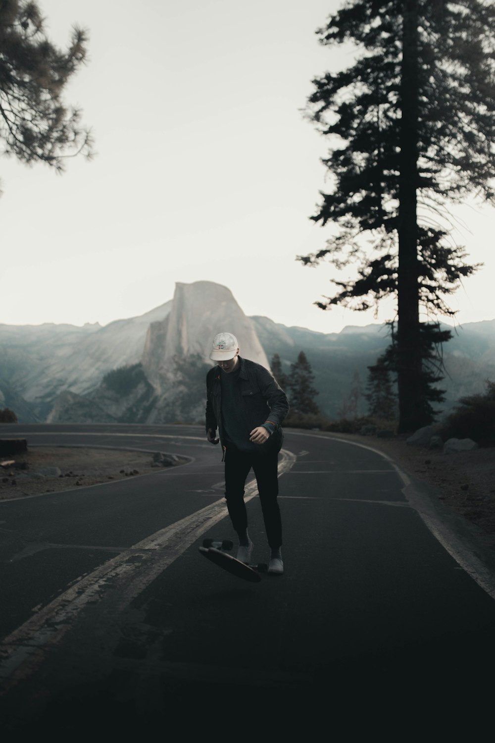 woman in black jacket standing on road during daytime