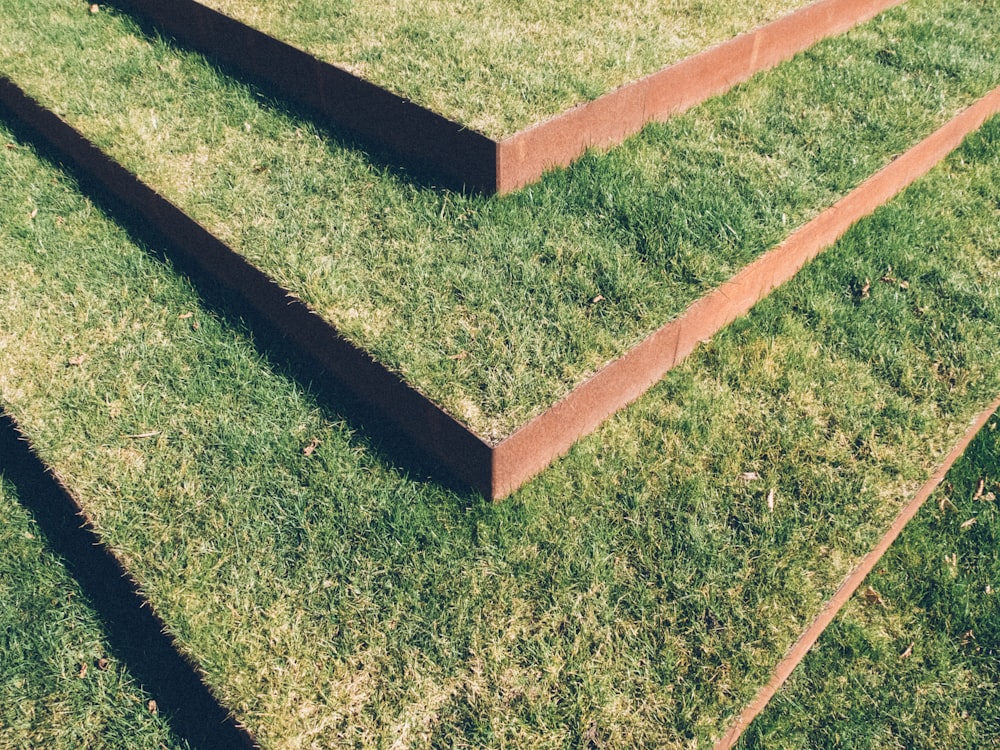 black and brown concrete blocks on green grass