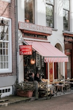 people sitting on chairs outside restaurant during daytime