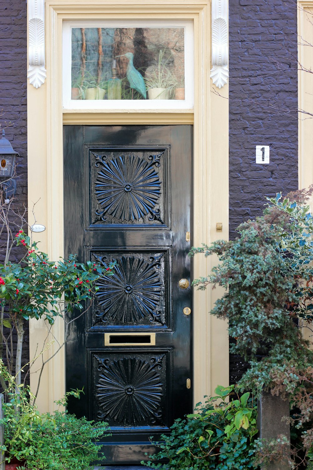 brown wooden door with green plant