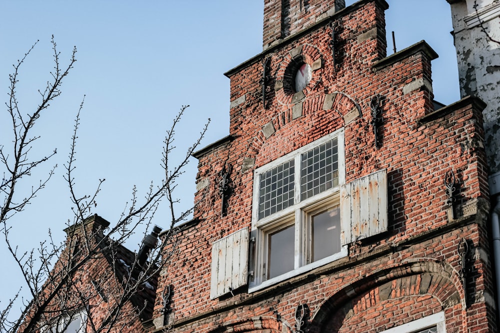 brown brick building with white window frame