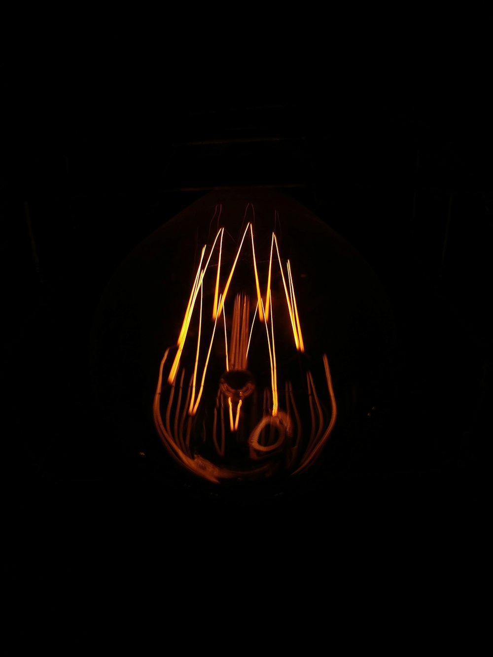 lighted round orange light in dark room