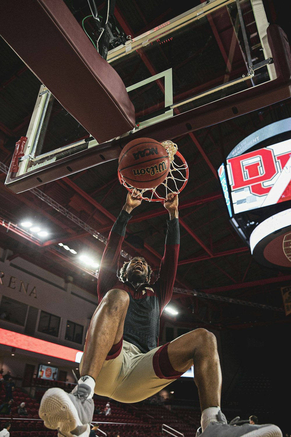 a man dunking a basketball in a gym