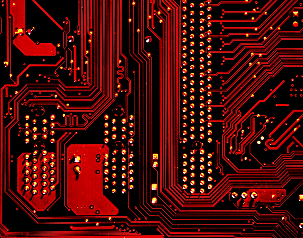 Red circuit board highlighting AI's role in data processing and workflow efficiency.