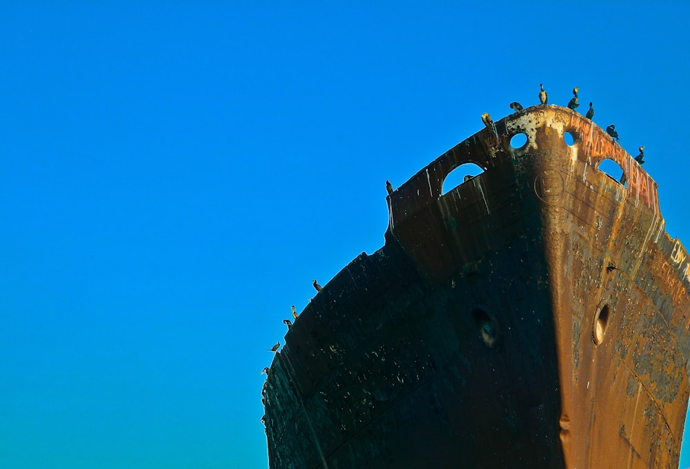 brown ship under blue sky during daytime
