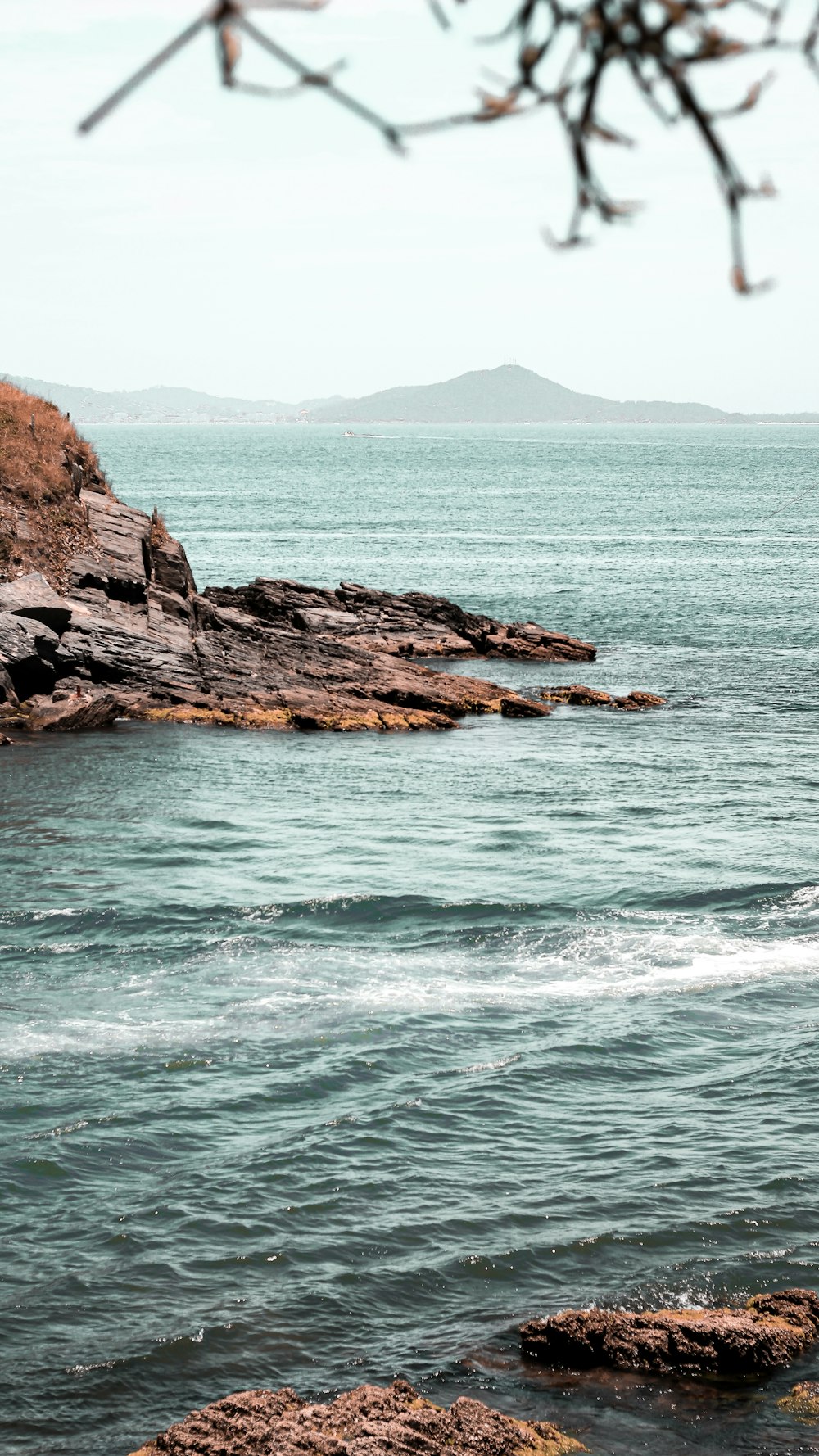 brown rock formation on sea during daytime