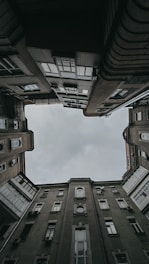 brown concrete building under white clouds during daytime