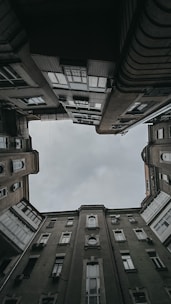 brown concrete building under white clouds during daytime