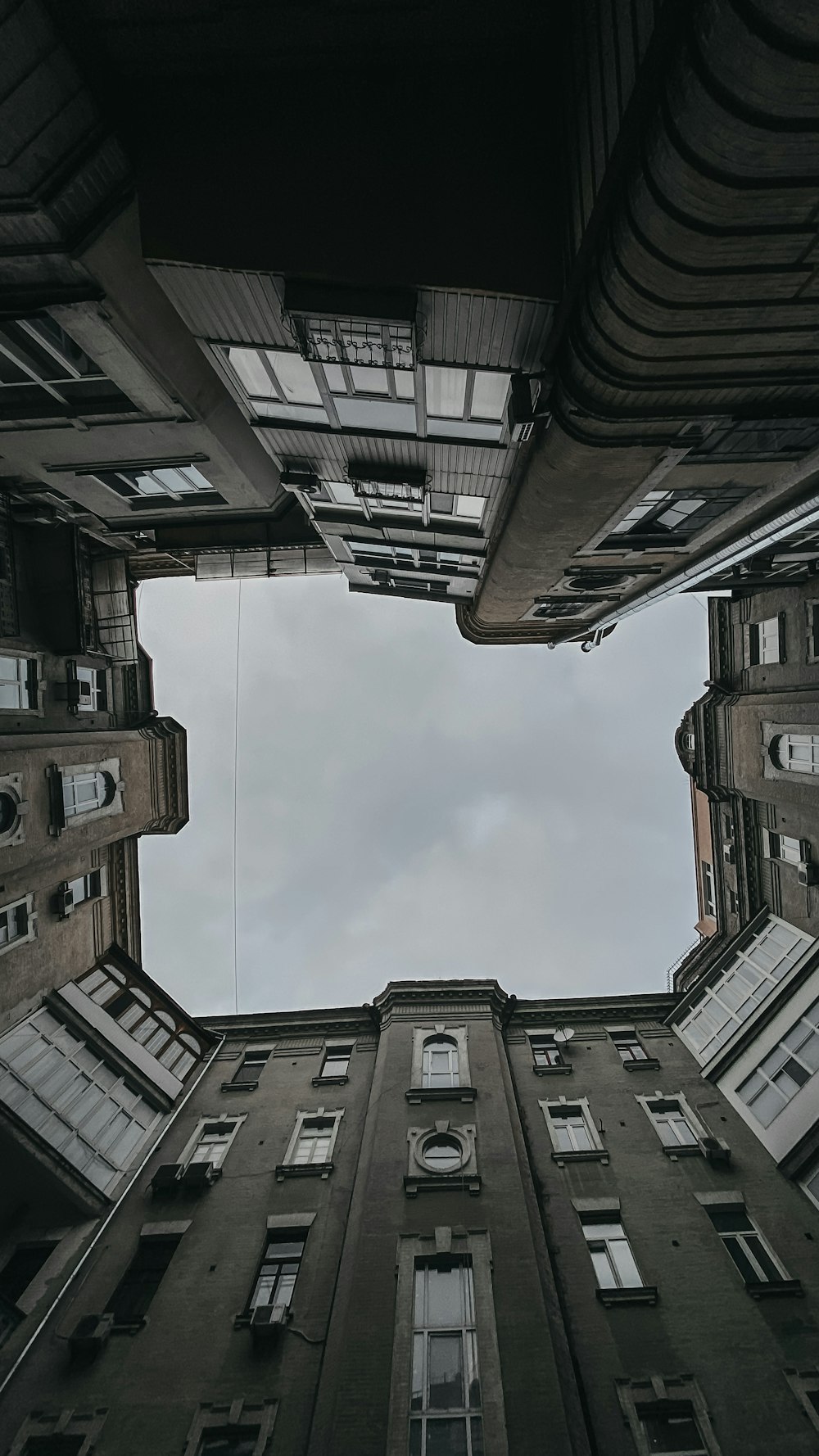 brown concrete building under white clouds during daytime