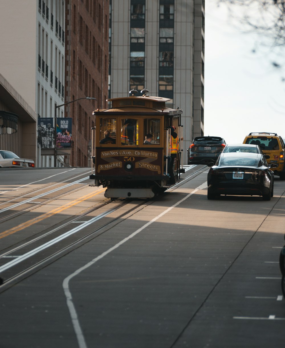 yellow tram on road during daytime