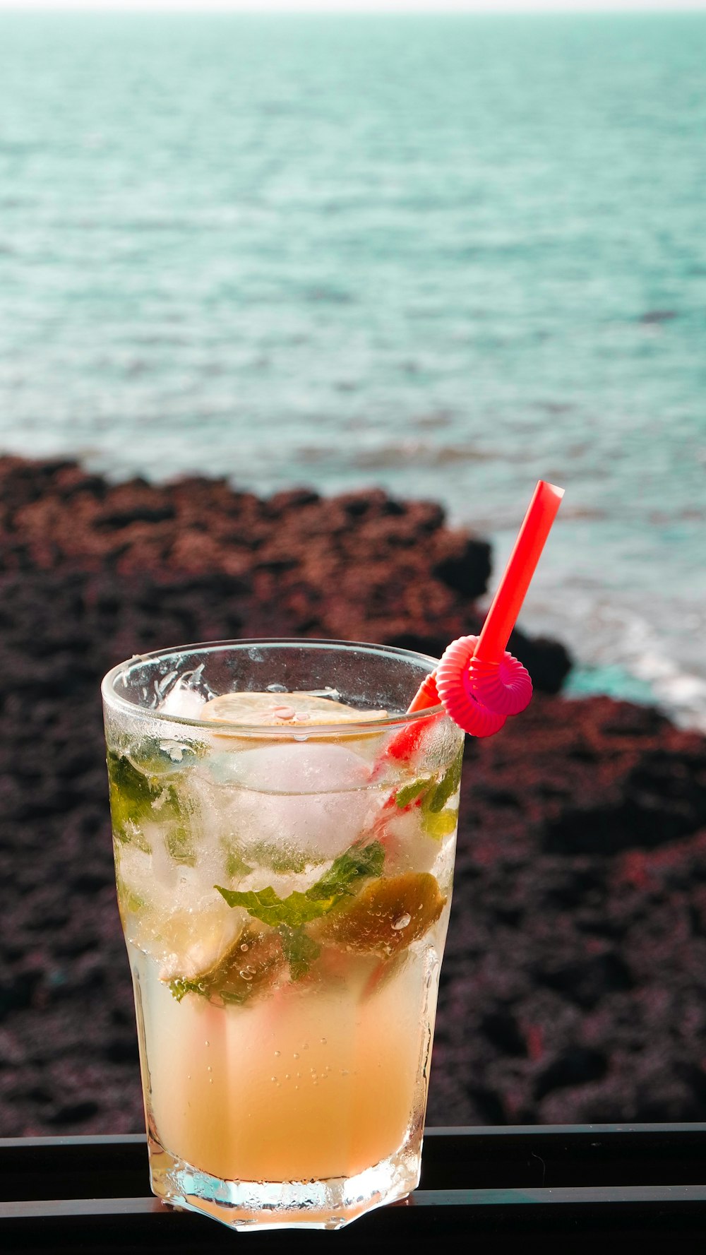 clear drinking glass with red straw