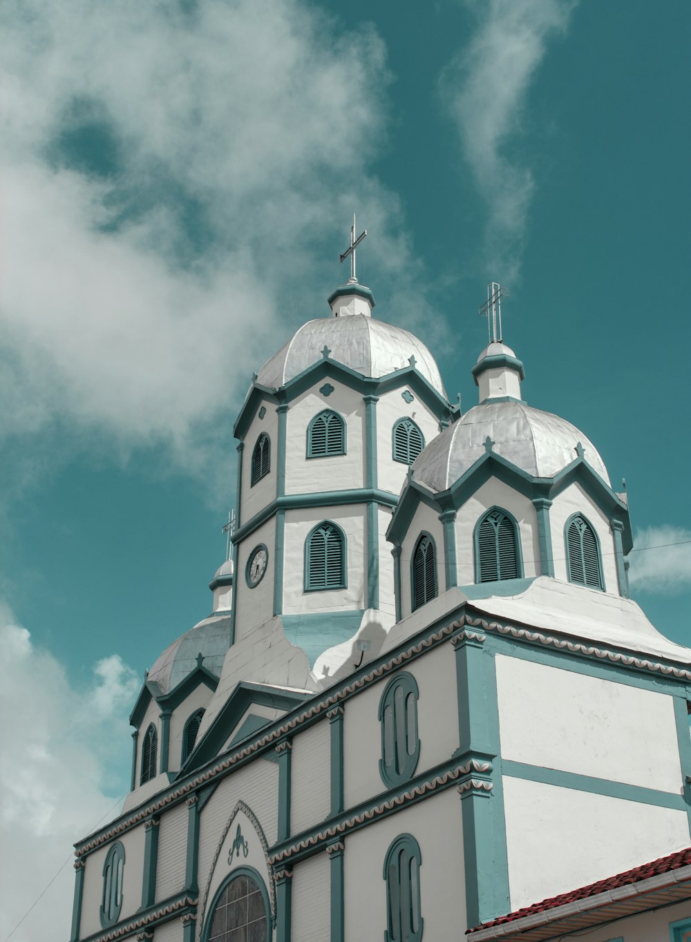 white and blue concrete building under white clouds