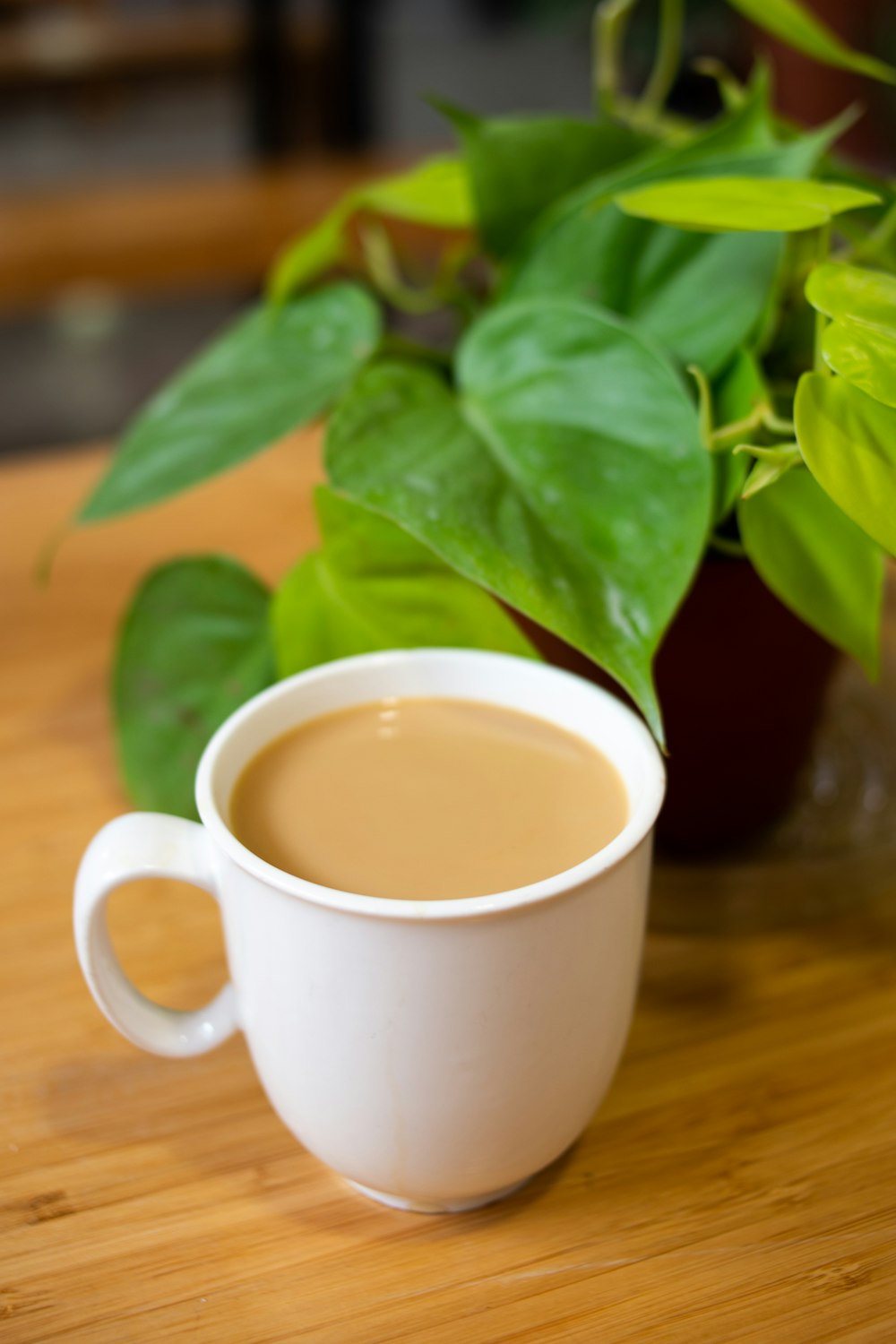 white ceramic mug with brown liquid inside