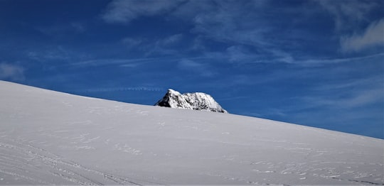 snow covered mountain under blue sky during daytime in Julierpass Switzerland