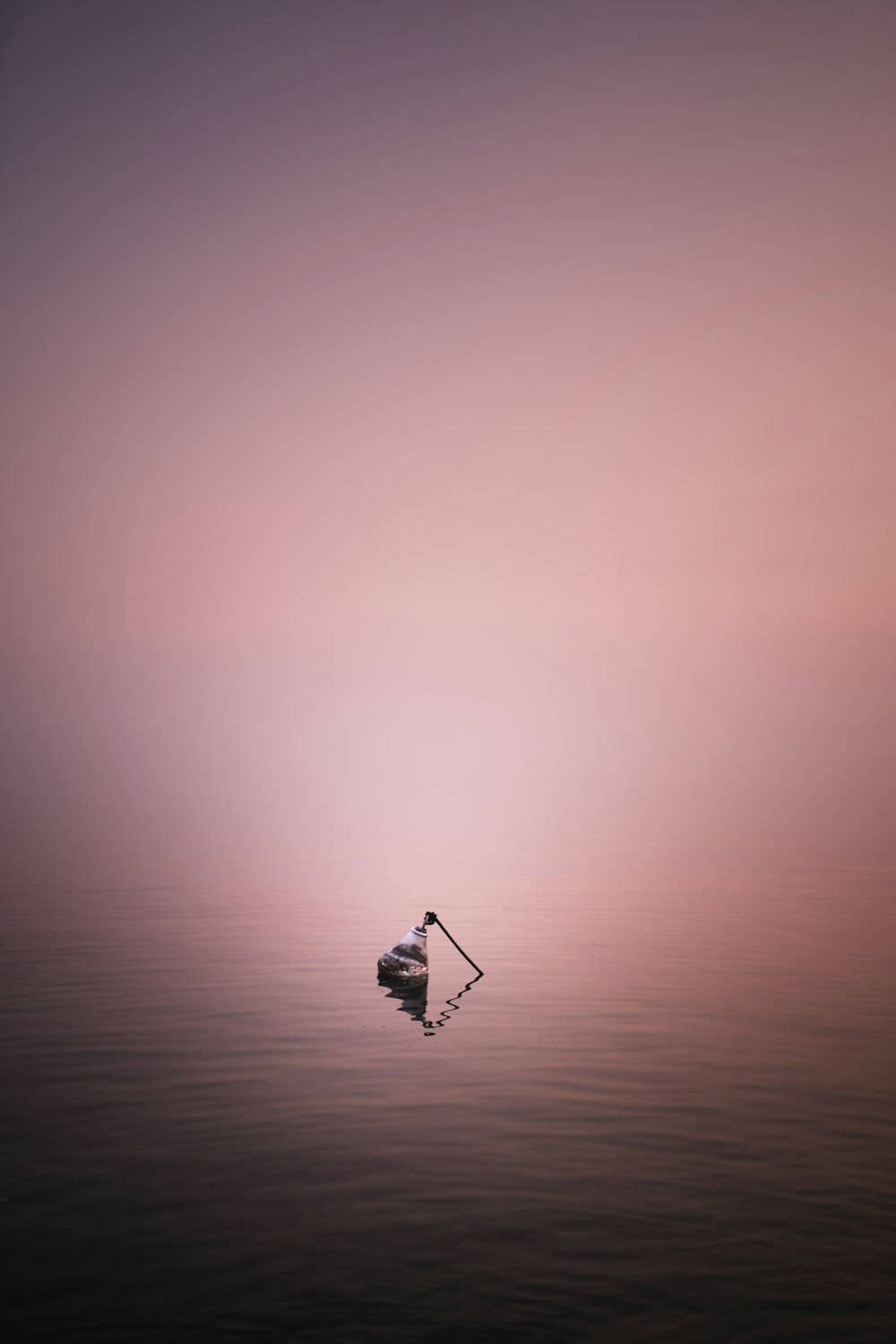 silhouette of a person on a boat on a body of water