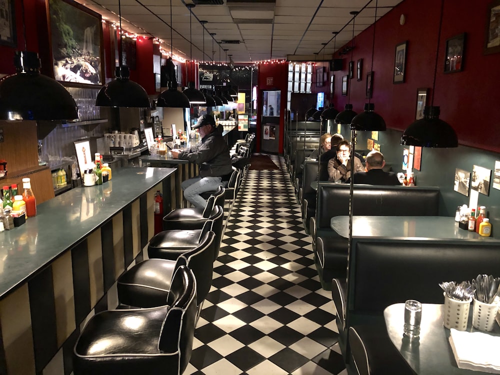 people sitting on chair inside restaurant