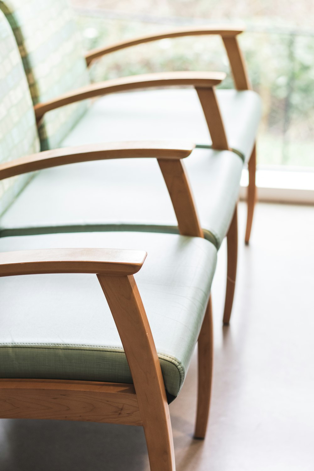 brown wooden framed white padded armchairs