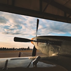 black and yellow plane under white clouds during daytime