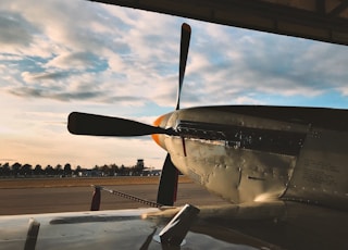 black and yellow plane under white clouds during daytime