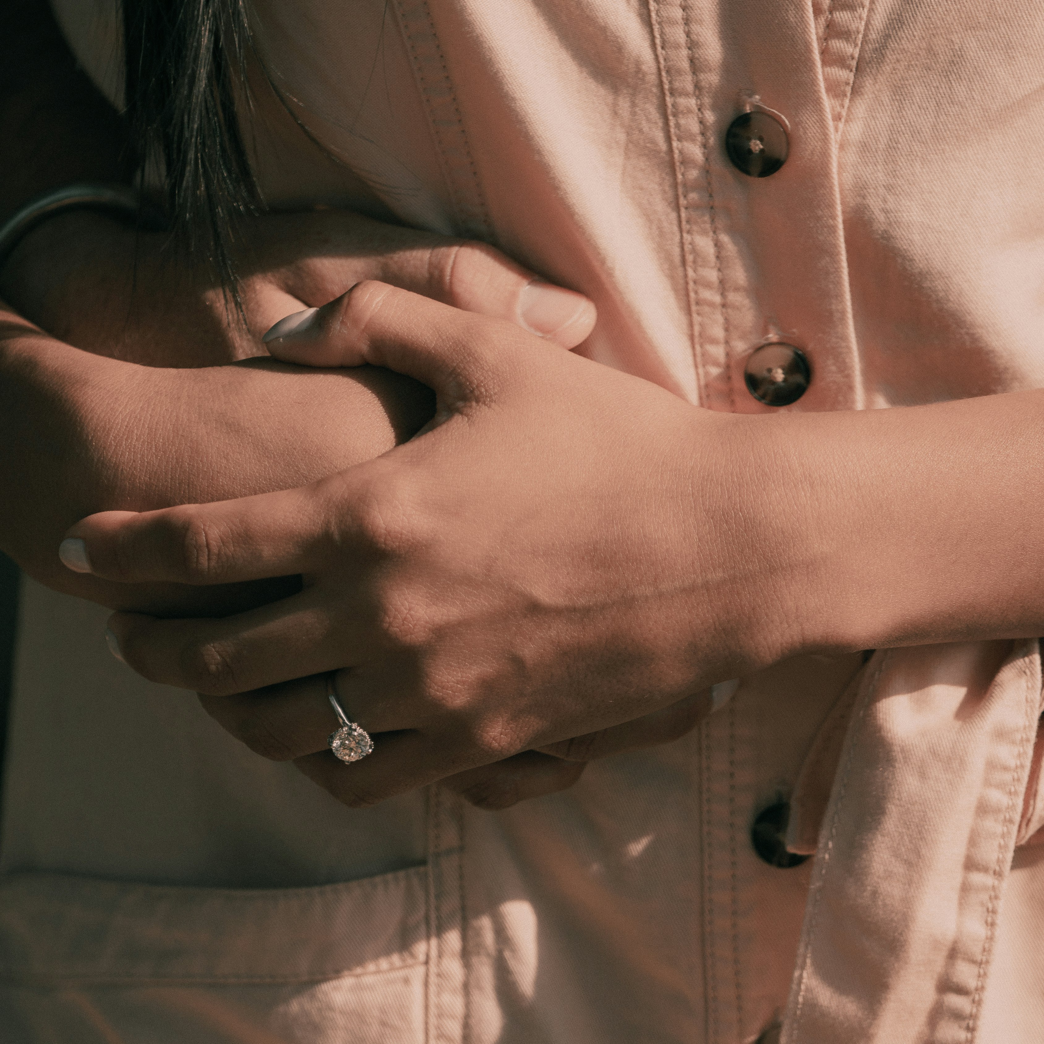 woman in white button up shirt wearing gold ring