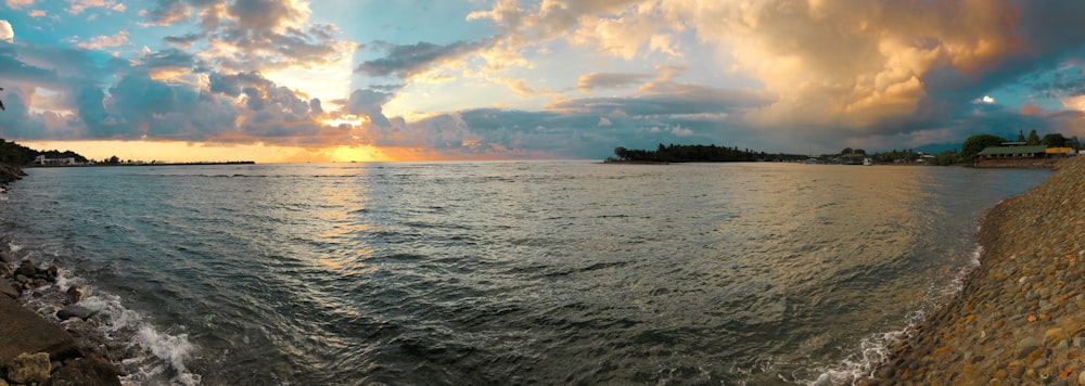 body of water under cloudy sky during daytime