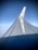 A view of an airplane wing with a clear blue sky in the background. The KLM logo is visible on the winglet, and there is a reflection of light on the smooth surface of the wing.