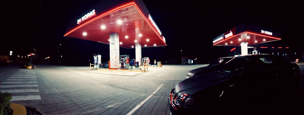 black car parked near red and white building during night time