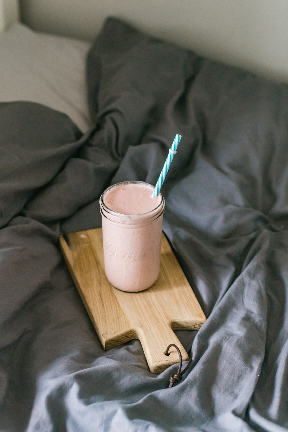 white ceramic mug with spoon on brown wooden table