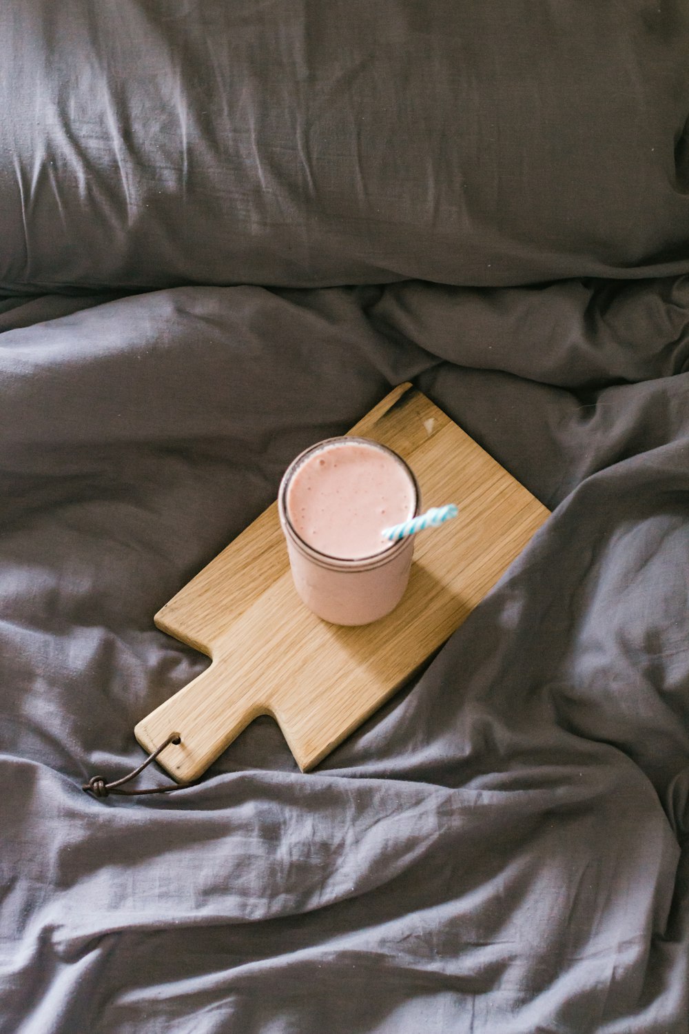 white ceramic mug on brown wooden chopping board