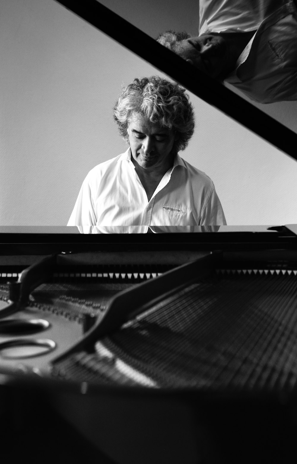 man in white dress shirt playing piano