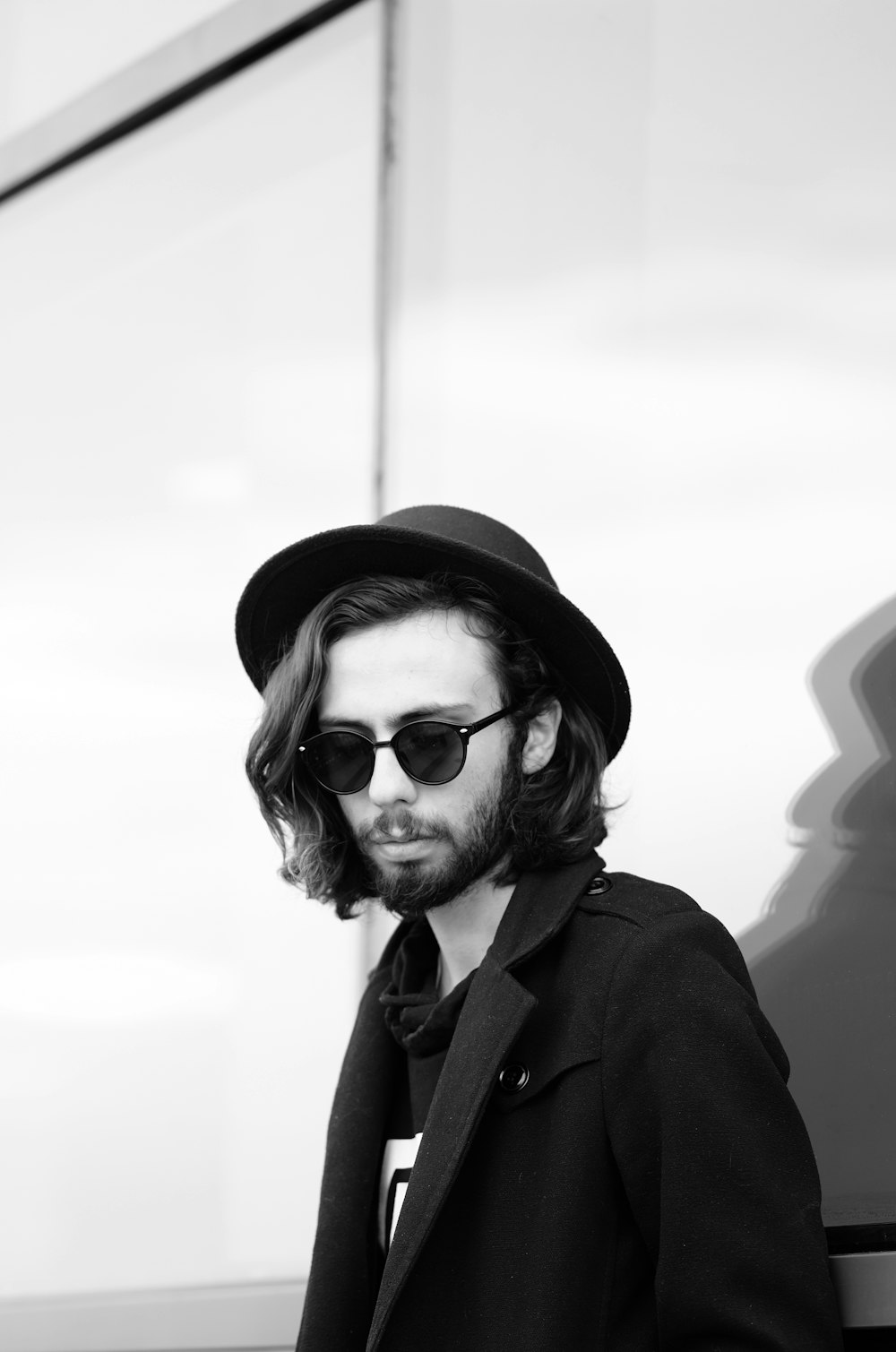 grayscale photo of man wearing sunglasses and hat