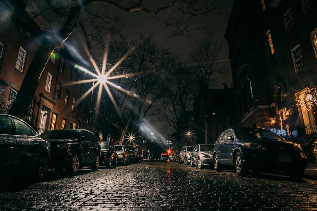 cars parked on side of the road during night time