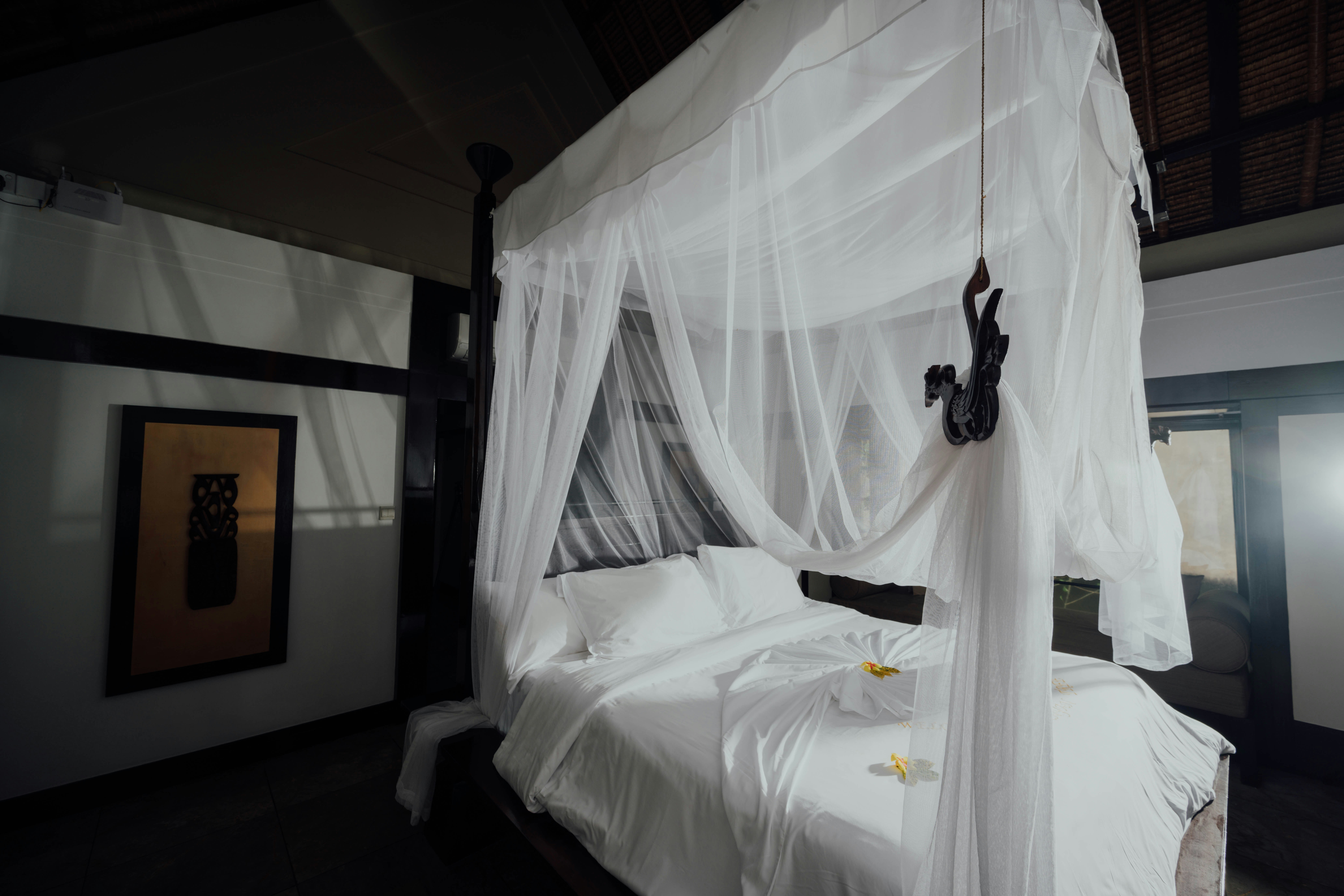 white bed linen with black headphones, 