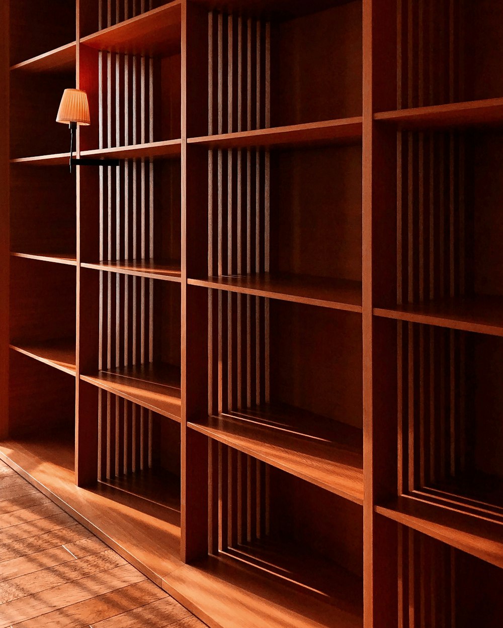 brown wooden shelves with white pendant lamp