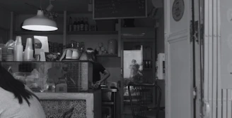 A friendly Cupmate staff member assisting a customer at a sleek grab-and-go counter.